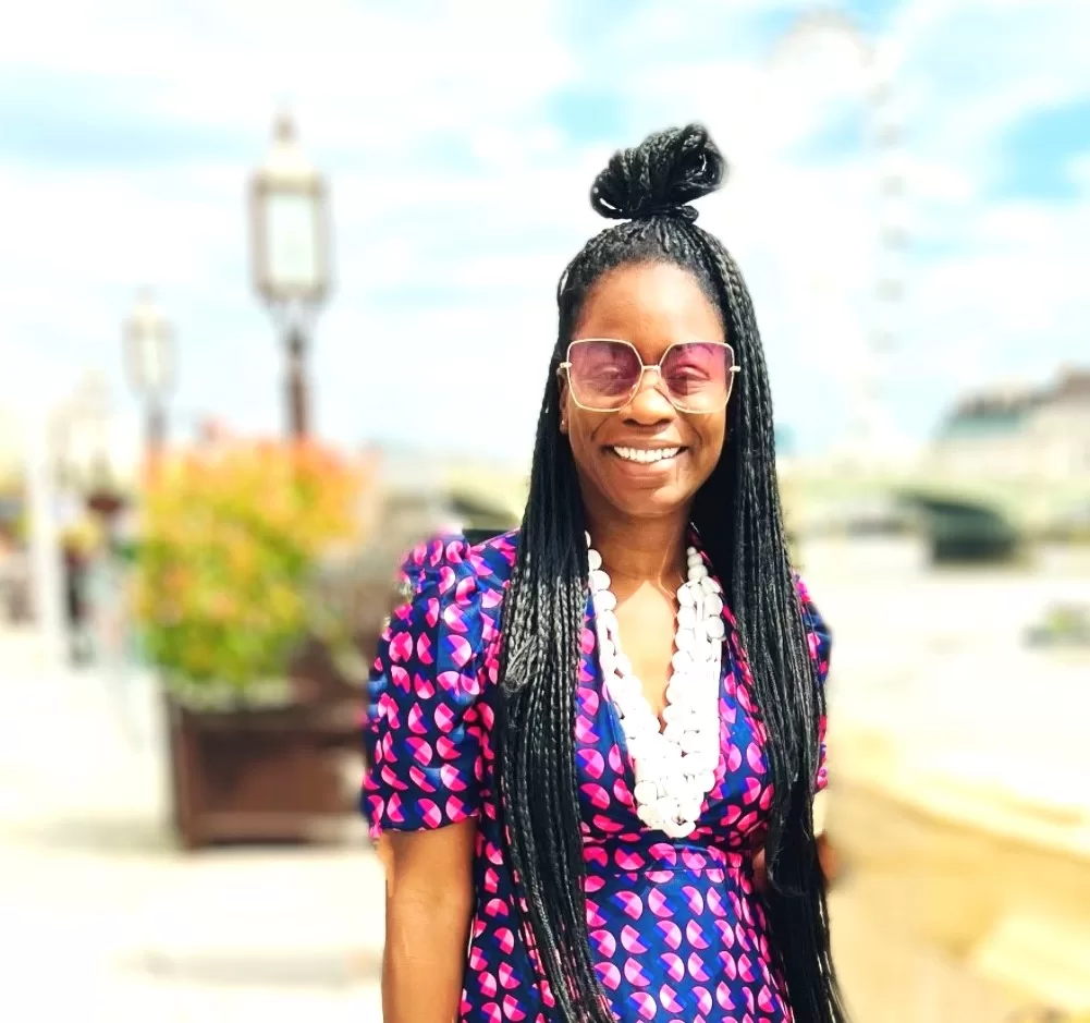 Image of Nadia Bob-Thomas wearing a colourful purple and blue dress